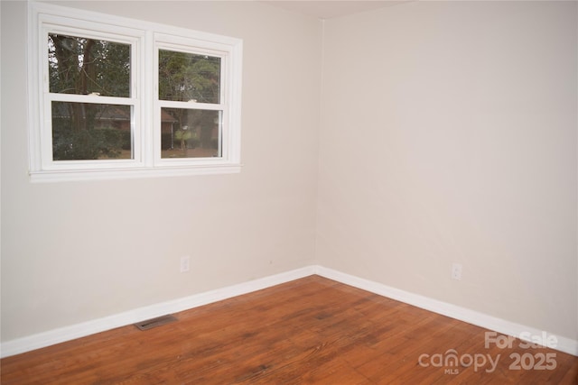 unfurnished room with hardwood / wood-style floors