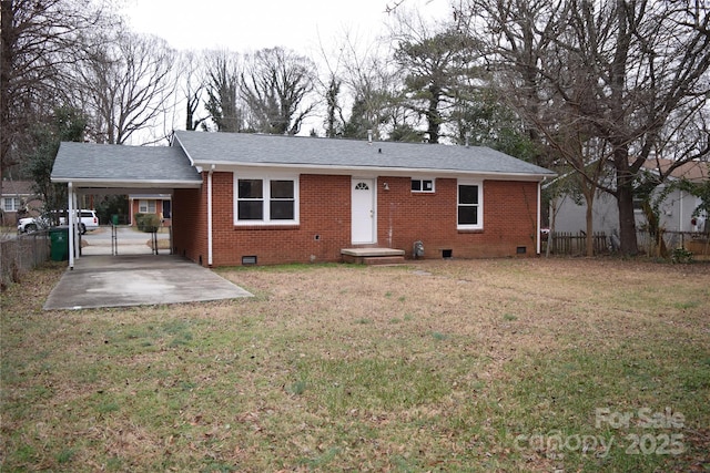 rear view of house with a yard and a carport