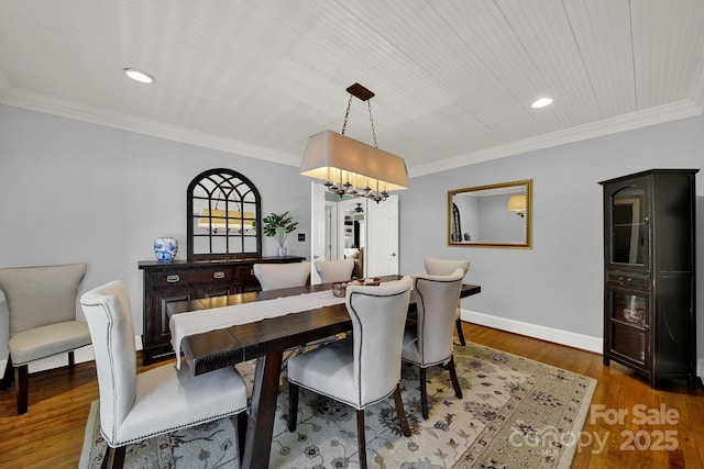 dining space with crown molding and dark wood-type flooring