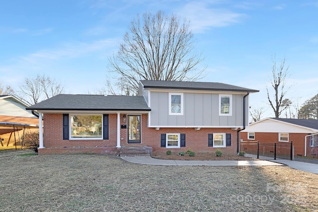 tri-level home featuring a front lawn