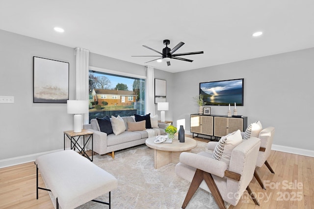 living room featuring light hardwood / wood-style flooring and ceiling fan