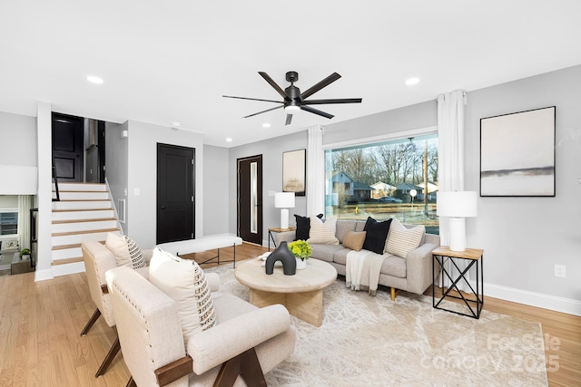 living room featuring ceiling fan and light wood-type flooring