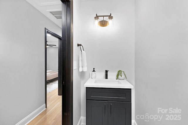 bathroom featuring hardwood / wood-style flooring, ceiling fan, and vanity