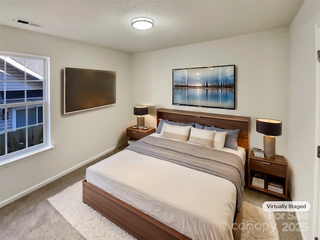 carpeted bedroom featuring a textured ceiling