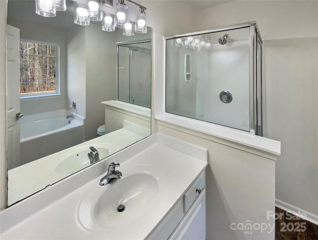 full bathroom featuring vanity, separate shower and tub, and toilet