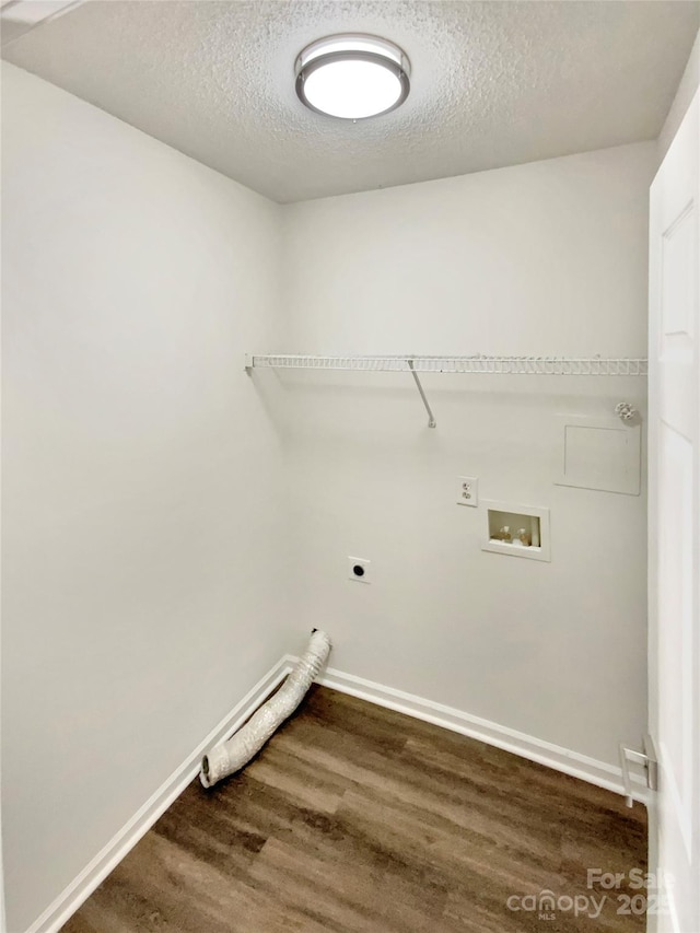 washroom with hookup for a washing machine, a textured ceiling, electric dryer hookup, and hardwood / wood-style floors