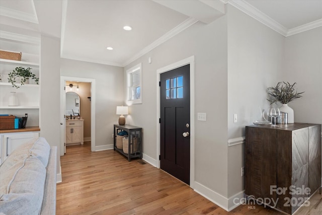 entrance foyer featuring crown molding and light hardwood / wood-style floors