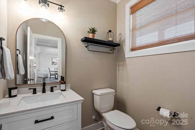 bathroom featuring toilet and vanity