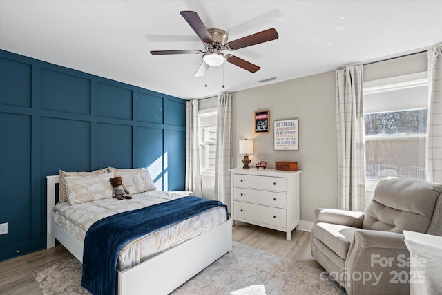 bedroom with ceiling fan and light hardwood / wood-style floors