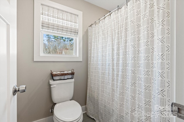 bathroom with toilet and walk in shower