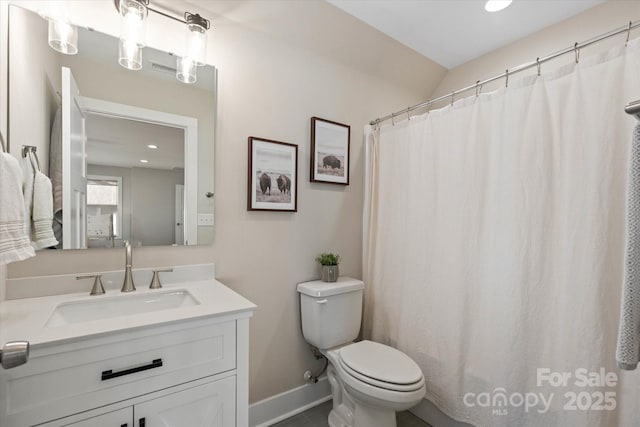 bathroom featuring toilet and vanity