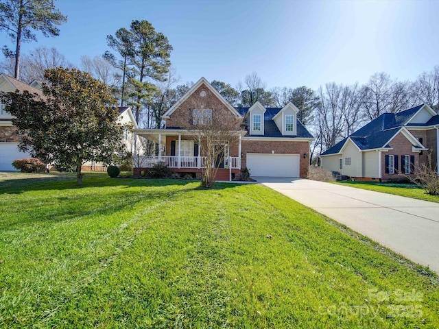 view of front of house with a porch, a garage, and a front yard