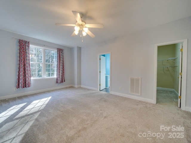 carpeted empty room with ceiling fan