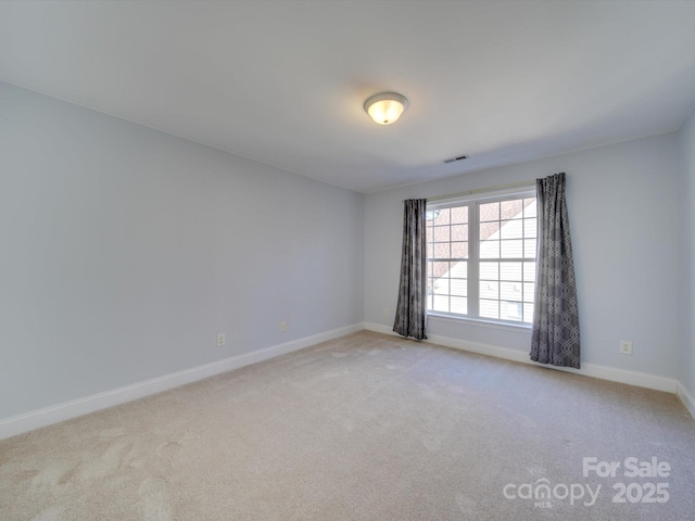 unfurnished room with light colored carpet