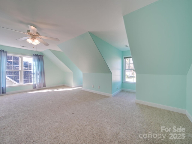 additional living space featuring ceiling fan, light carpet, and vaulted ceiling