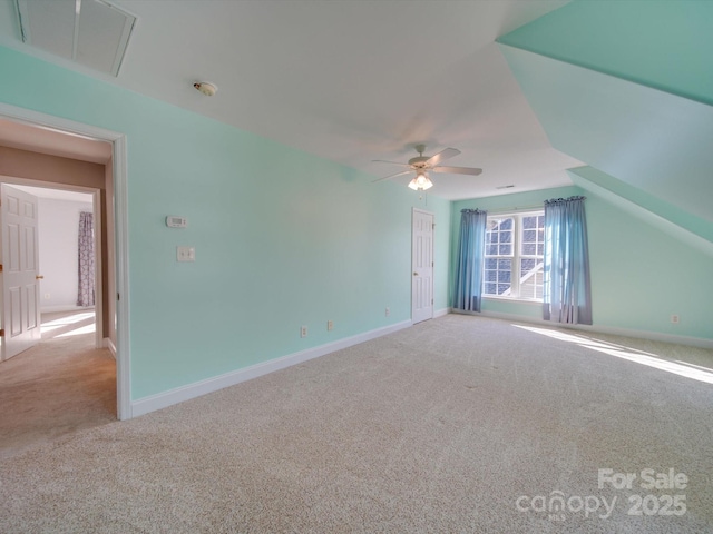 interior space featuring carpet flooring, vaulted ceiling, and ceiling fan