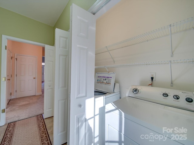 laundry room featuring washer and clothes dryer and light tile patterned floors