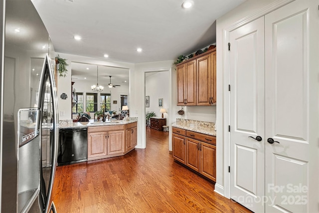 kitchen featuring a sink, black dishwasher, wood finished floors, recessed lighting, and stainless steel fridge with ice dispenser