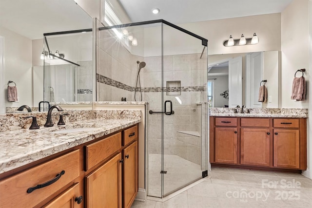 bathroom with vanity, tile patterned floors, and a shower with shower door