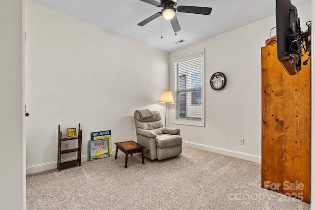 living area featuring carpet flooring, baseboards, visible vents, and ceiling fan