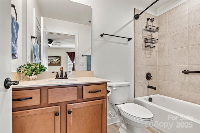 bathroom featuring toilet, vanity, and bathtub / shower combination