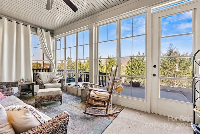 sunroom / solarium featuring ceiling fan