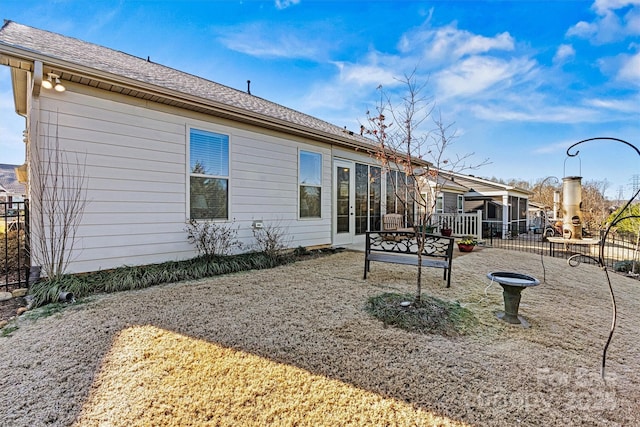 back of house featuring a patio and fence