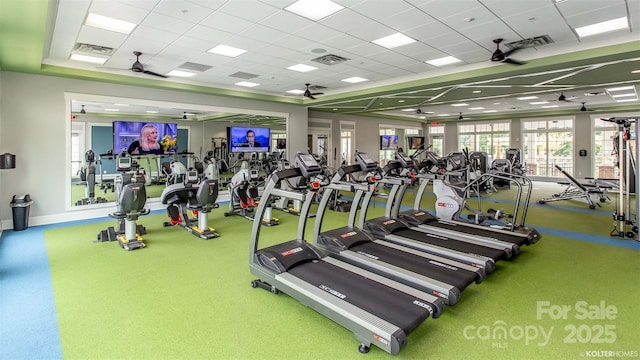 exercise room featuring visible vents, a ceiling fan, and a drop ceiling