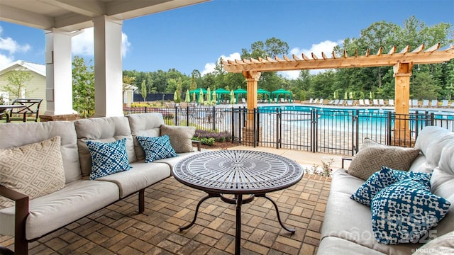 view of patio / terrace with an outdoor living space, a pergola, a community pool, and fence