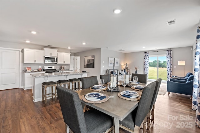 dining room with dark hardwood / wood-style flooring