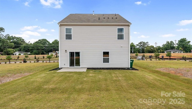 back of property with a lawn and a patio