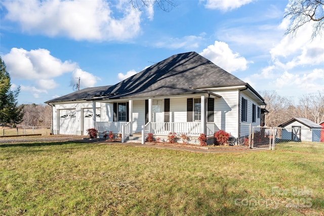 ranch-style home featuring a front lawn, a porch, and a garage