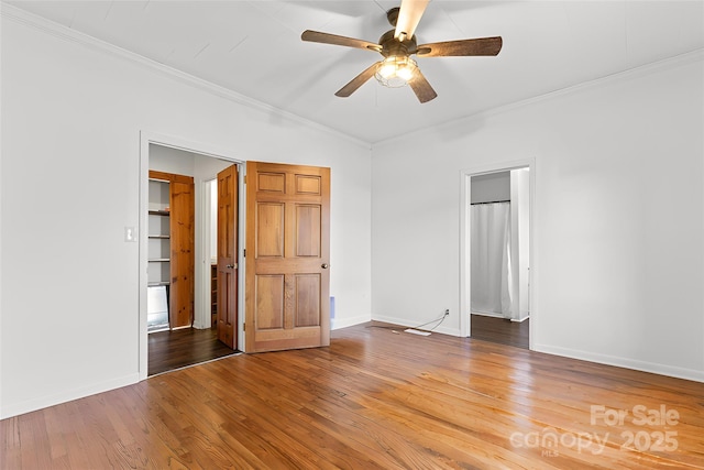 unfurnished bedroom with ceiling fan, crown molding, and hardwood / wood-style flooring