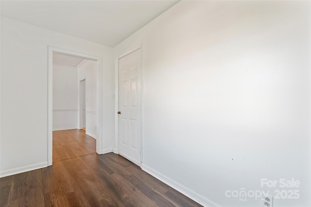 corridor with dark hardwood / wood-style floors