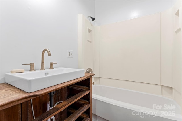 bathroom featuring shower / bath combination and sink