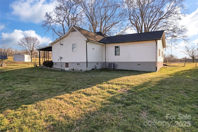 view of side of property featuring central air condition unit and a lawn