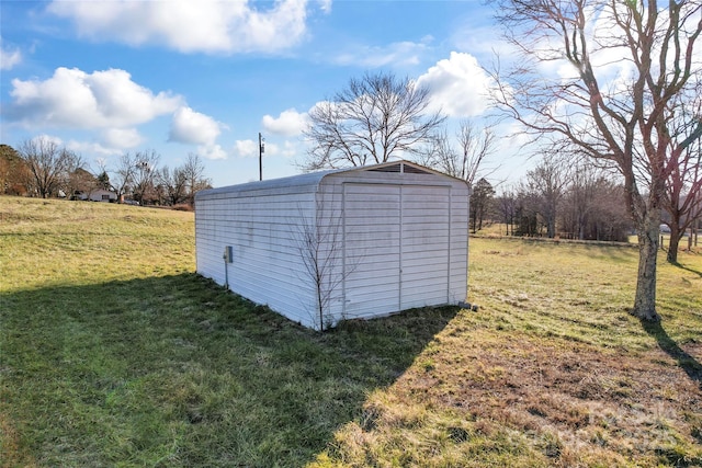 view of outbuilding with a lawn