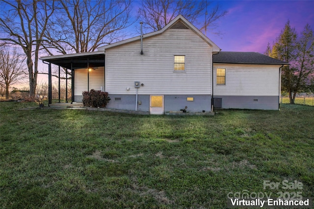 property exterior at dusk featuring a yard and central air condition unit