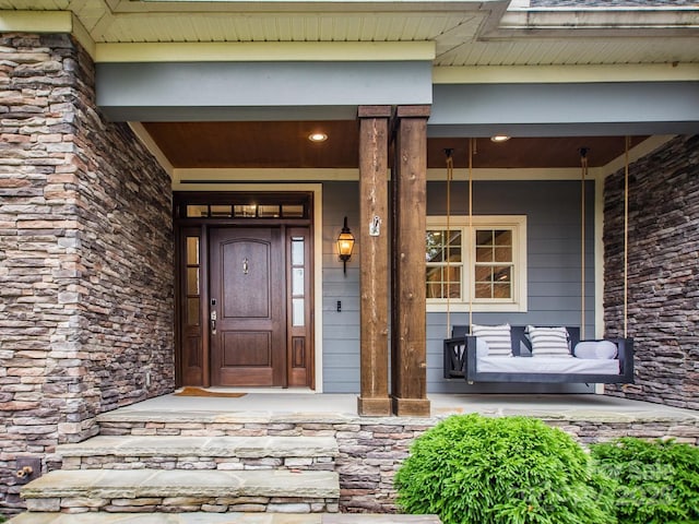 doorway to property featuring a porch