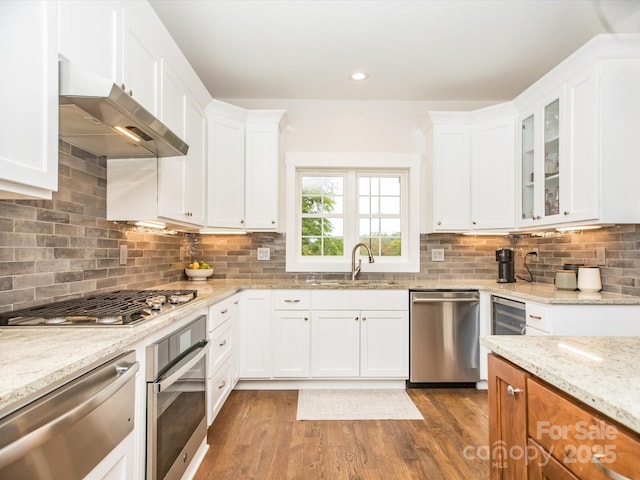 kitchen featuring white cabinets, stainless steel appliances, and sink