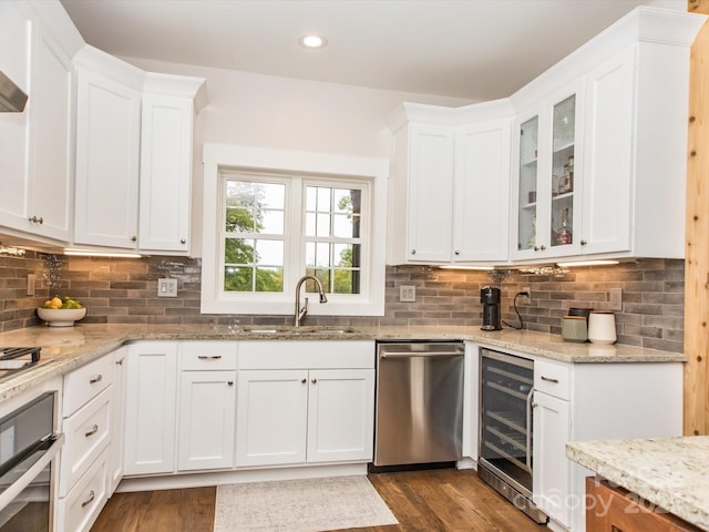 kitchen with white cabinets, wine cooler, sink, and appliances with stainless steel finishes