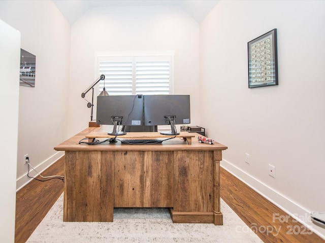 office space featuring hardwood / wood-style floors and lofted ceiling