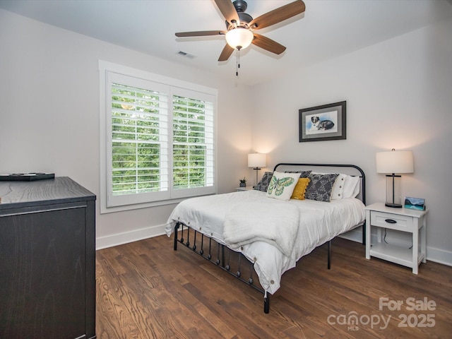 bedroom with ceiling fan and dark hardwood / wood-style flooring