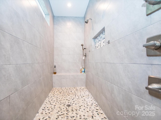 bathroom with tiled shower