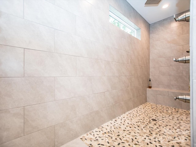 bathroom with a tile shower