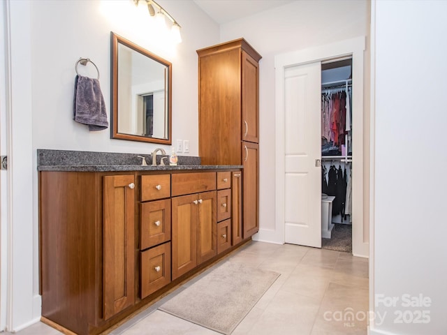 bathroom featuring tile patterned flooring and vanity