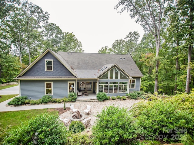 back of house with a patio and a fire pit