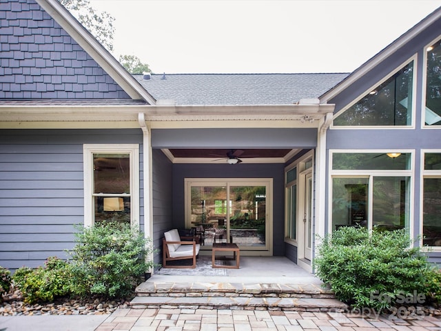 entrance to property featuring a patio and ceiling fan