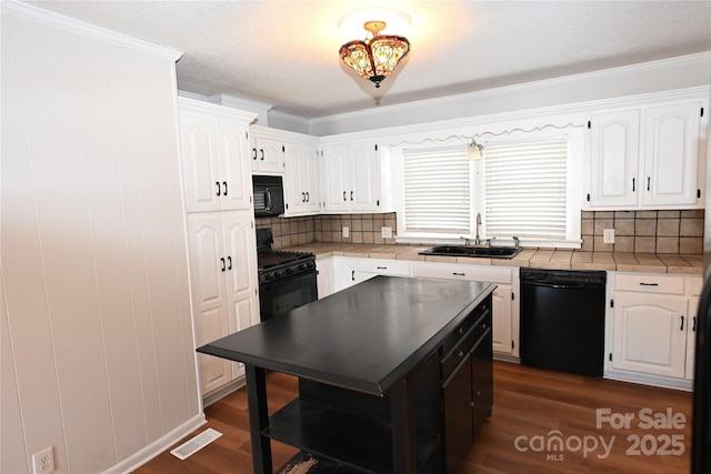 kitchen featuring black appliances, white cabinets, sink, ornamental molding, and dark hardwood / wood-style flooring