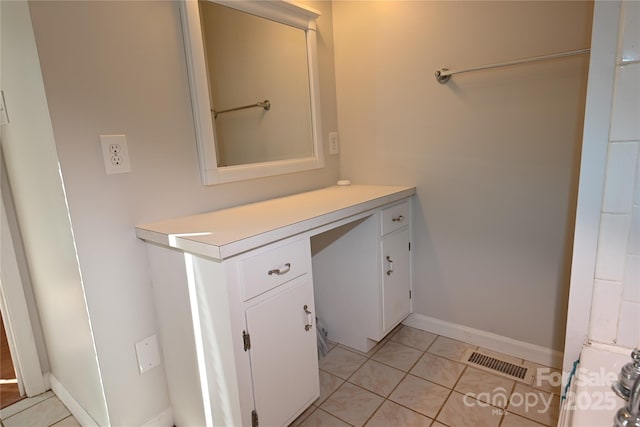 bathroom with tile patterned floors and vanity